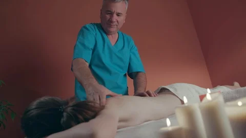 Professional Masseur Doing Deep Tissue Oiled Massage to a Girl at Ayurveda Stock Footage 119518550