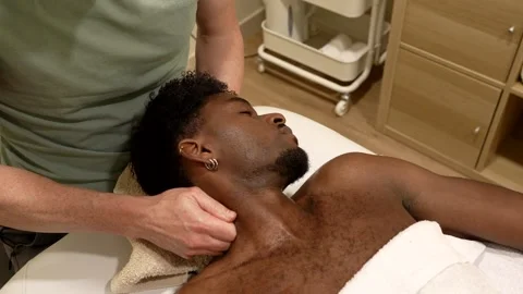 Professional masseur massaging a client's neck and shoulders Stock Footage 328716632