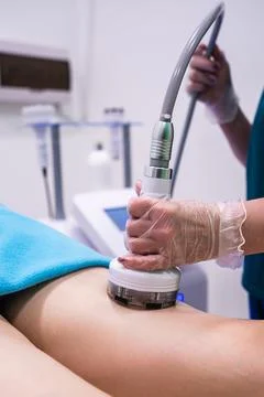 Professional masseuse using modern device for RF lifting procedure, health .. Stock Photos