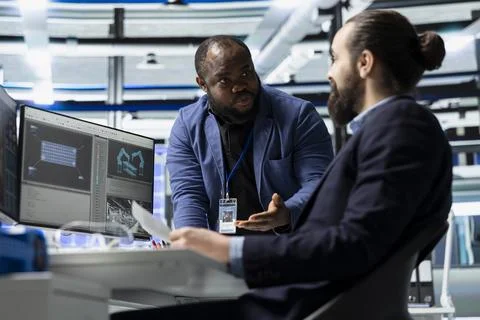 Professional master engineers team inspecting control panels and analyze data Stock Photos