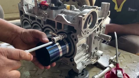 Professional mechanic assemble car engine piston in cylinder block Stock Footage 160987889