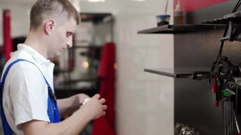 Professional mechanic assembles engine with care, installing pistons, rings Stock Footage 273513693