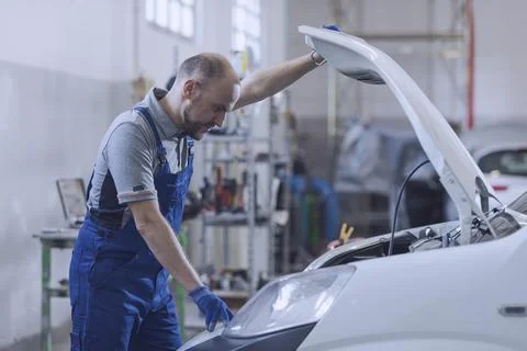 Professional mechanic checking the car engine Stock Photos