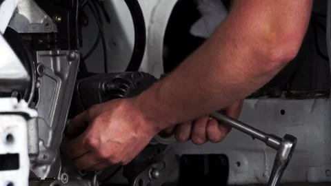 Professional mechanic fix a car engine in repair shop. Footage. Closeup view Stockbeeldmateriaal 139709008