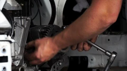 Professional mechanic fix a car engine in repair shop. Footage. Closeup view Stock Photos