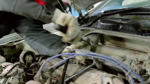 Professional mechanic fixing car engine with specialized tools in modern auto Stock Footage 328020915