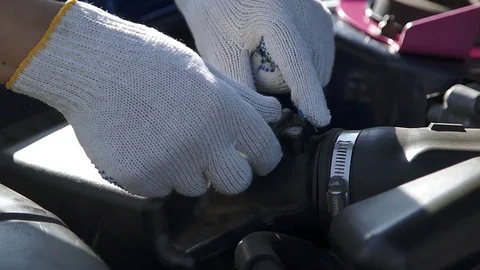 Professional mechanic sets the oxygen sensor Stock Footage 73554644