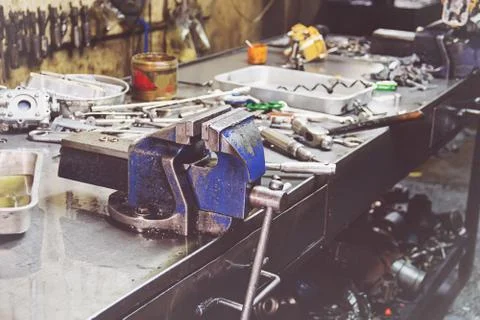 Professional mechanic using different tools for working in auto repair servic Stock Photos