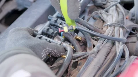 Professional mechanic wearing gloves installing or repairing car engine gas fuel 스톡 동영상 329285167