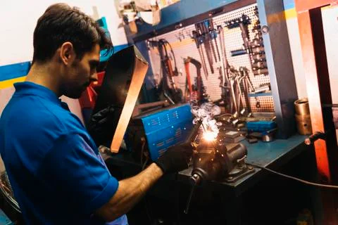 Professional Mechanic welding. Stock Photos