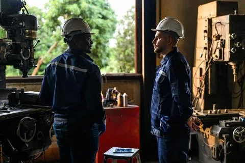 Professional mechanical engineer team checking and repairing engine machine 스톡 사진