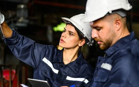 Professional mechanical engineer team checking and repairing engine machine 库存照片