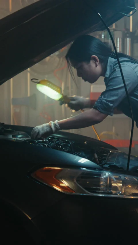 Professional Mechanics Working Under Hood Car in Modern Garage 스톡 동영상 330272584