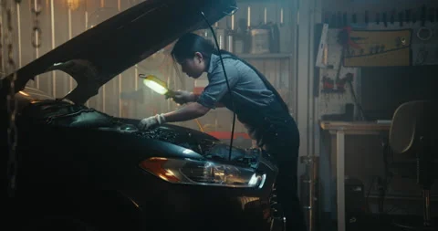 Professional Mechanics Working Under Hood Car in Modern Garage 스톡 동영상 330273588