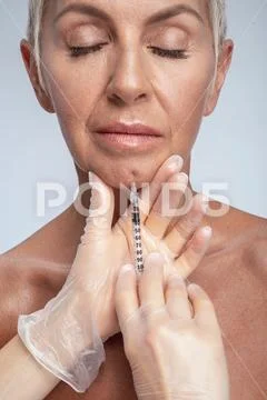 Professional medical worker doing injection for her client Stock Photos
