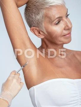 Professional medical worker doing injection for client Stock Photos