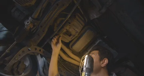 Professional men mechanic working under lifted car at auto repair shop. Video stock 100237794
