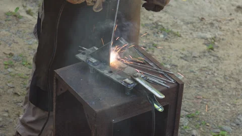 Professional Metal Welder Using Arc Welding Equipment in an Outdoor Workshop Stock Footage 337427175