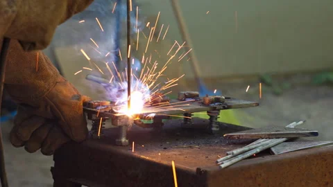 Professional Metal Welder Using Electric Arc Welding Tools in a Workshop Stock Footage 337425214