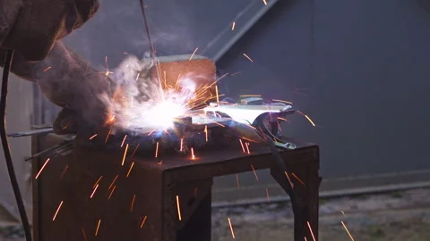 Professional Metal Welding Process with Bright Sparks in a Workshop Setting Stock Footage 337431515
