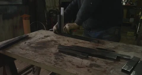 Professional metalworker using a try square to align two pieces of rectangular 動画素材 330782115