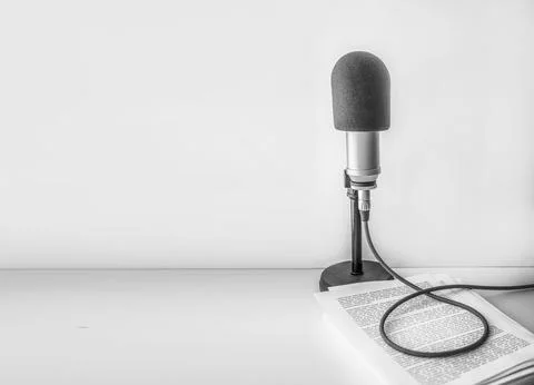 Professional microphone and text on sheets of paper background Fotos de archivo