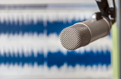 Professional microphone and text on sheets of paper background Fotos de archivo