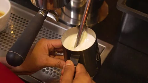 Professional Milk Steaming Technique at Stainless Steel Espresso Machine in Stockbeeldmateriaal 336418087