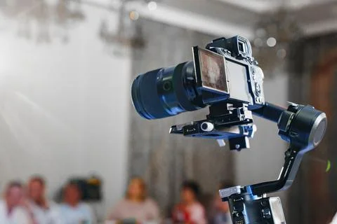 Professional mirrorless camera on electronic gimbal stabilizer Stock Photos