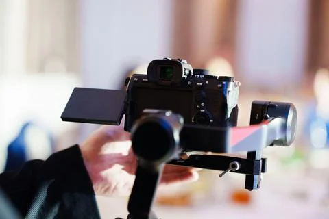 Professional mirrorless camera mounted on a gimbal stabilizer Stock Photos