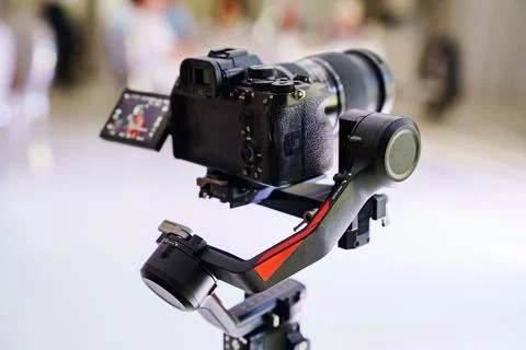 Professional mirrorless camera mounted on gimbal stabilizer Stock Photos