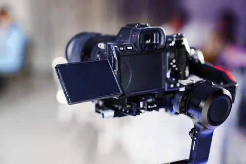 Professional mirrorless camera mounted on a gimbal stabilizer Stock Photos