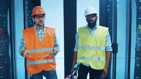 Professional mixed race team of electrical technician workers inspecting server Stock Footage 120747520