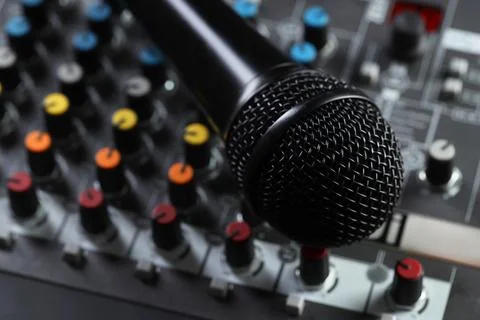 Professional mixing console with microphone, closeup. Radio studio equipment Stock Photos