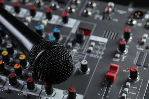 Professional mixing console with microphone, closeup. Radio studio equipment Stock Photos