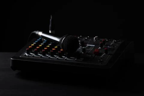 Professional mixing console with microphone on table against black backgrou.. Stock Photos
