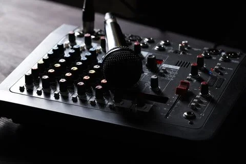 Professional mixing console with microphone on table, closeup Stock Photos