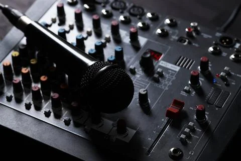 Professional mixing console with microphone on table, closeup Stock Photos