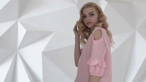 Professional model posing on camera in studio. Shooting for advertising clothes Stock Footage 87563421