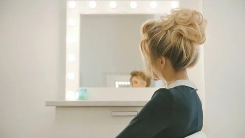 Professional model posing on camera. Turn on around chair Stock Footage 74477344