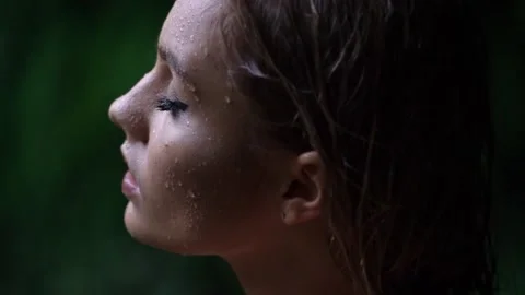 Professional model with water drops on face turns head Stock Footage 139097074