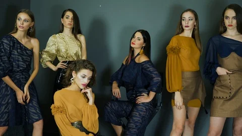 Professional models with perfect makeup posing in fashionable clothes  in studio Stock Footage 93542255