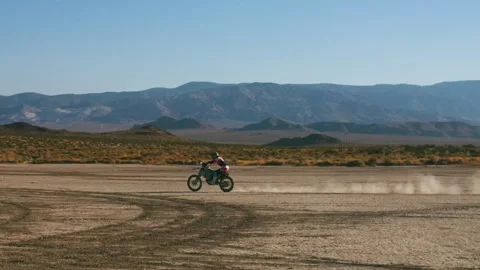 Professional motocross rider racing through desert landscape Video stock 332794553