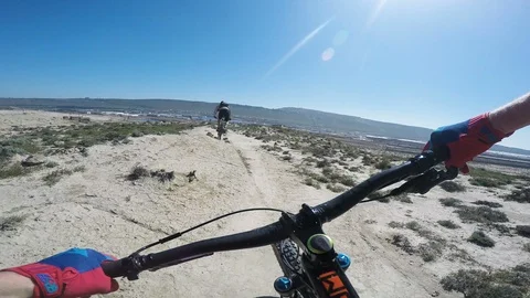 Professional Mountain Bikers Riding Fast In The Desert Video stock 101498692