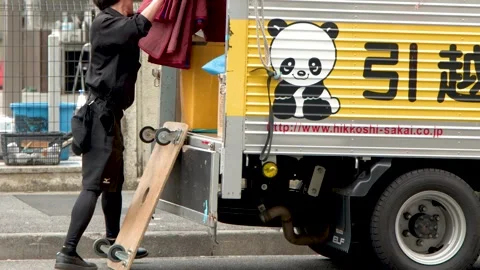 Professional Mover Loading Equipment into Delivery Truck in Tokyo Stock Footage 341853075