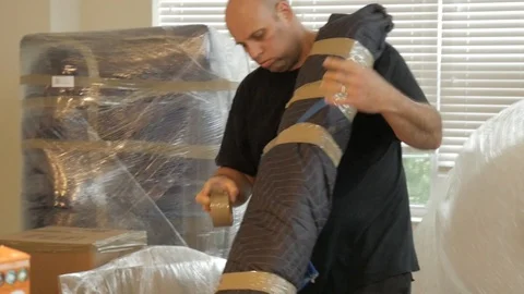 Professional Mover Using Packing Tape Apartment Move Handheld Stock Footage 129499689