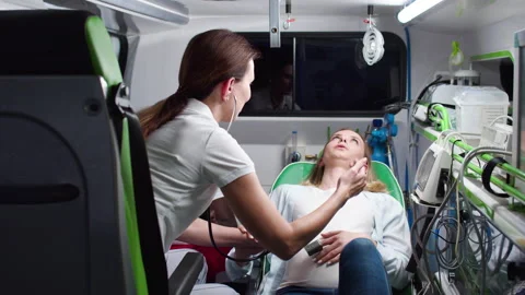 Professional multiethnic paramedics providing help measuring heartbeat of baby Video stock 225472682
