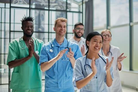 Professional multinational doctors applauding in front of the camera. Diagnostic Stock Photos
