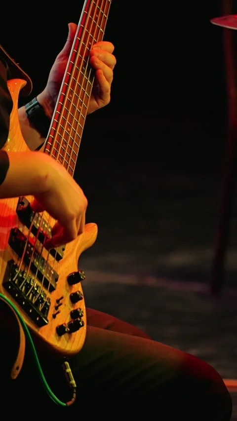 A professional musician plays a five-string bass guitar quickly and skillfully Video stock 308061416
