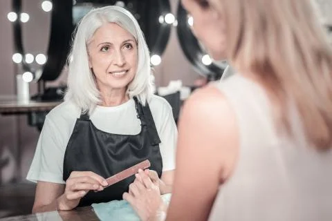Professional nail master doing manicure Stock Photos